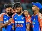 India's Hardik Pandya (C) celebrates with captain Suryakumar Yadav (R) and Mohammed Siraj after taking the wicket of Sri Lanka's Kusal Perera