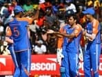 India's Ravi Bishnoi (C) celebrates with teammates