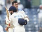 India's Ravichandran Ashwin celebrates after scoring a century with Ravindra Jadeja