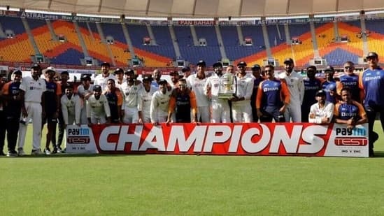 Members of the Indian cricket team pose with the Anthony de Mello trophy after beating England by an innings and 25 runs on Saturday