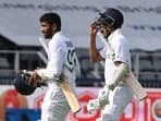 Jasprit Bumrah (L) and Mohammed Siraj return after India bowled out for 376