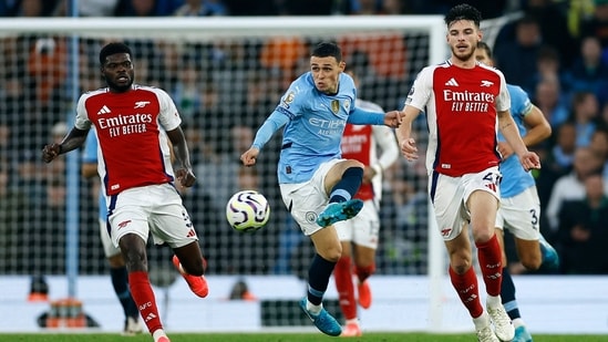 Manchester City's Phil Foden in action with Arsenal's Declan Rice.